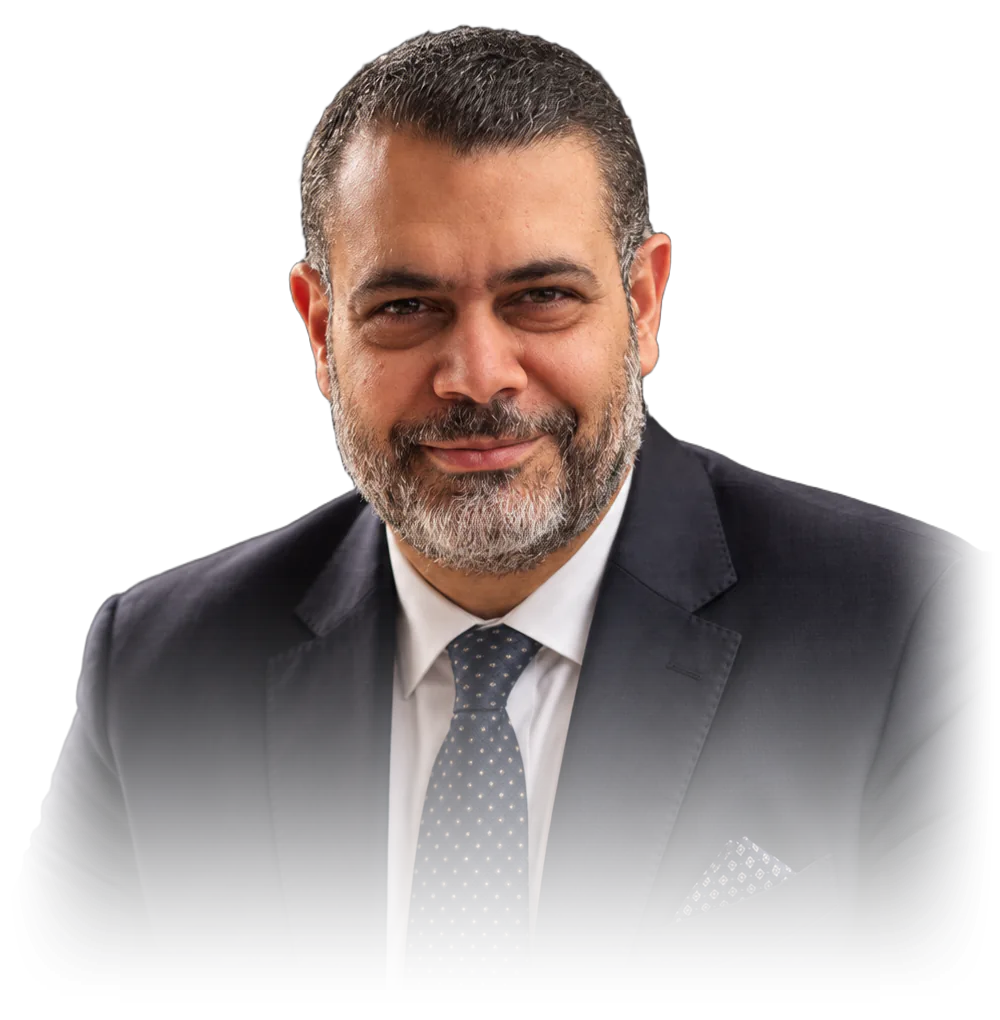 Prof. Dr. Mohamed Mokhtar Mabrouk, seated, in a navy suit